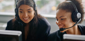 Two individuals in a call centre environment.