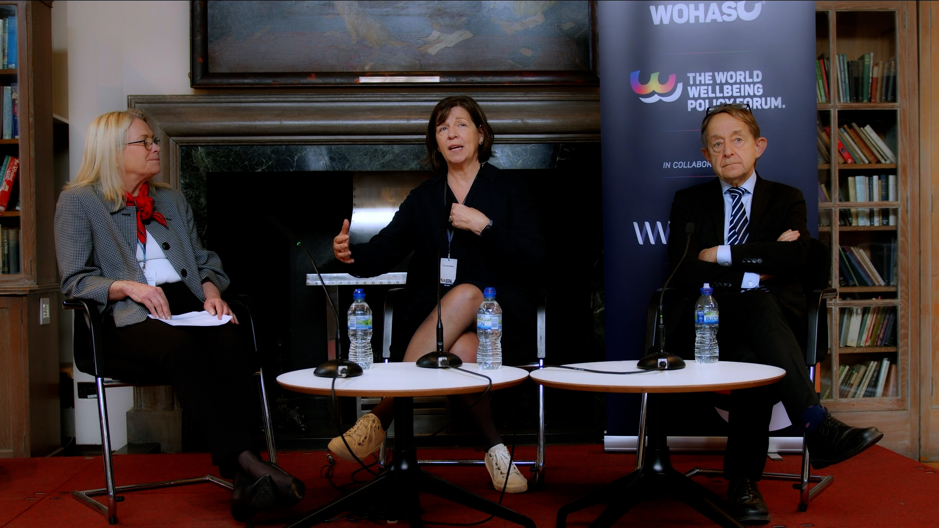 Ambassador Pilar Saborio de Rocafort, Sir Anthony Seldon, and Lucy Bailey on stage at the World Wellbeing Policy Forum discussing the Role of Education