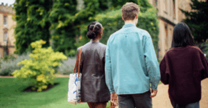 3 people walking in greenery